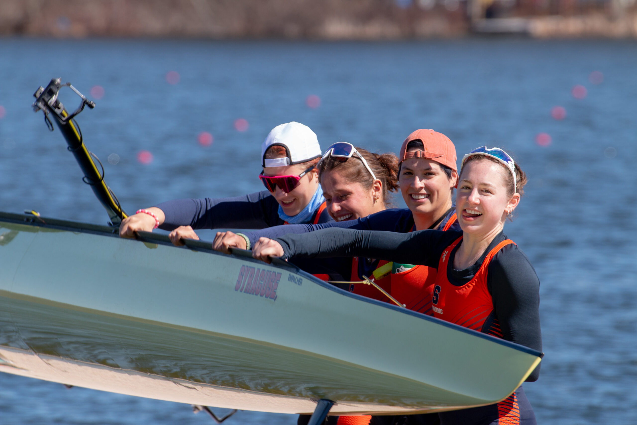 A group of people holding a boat.