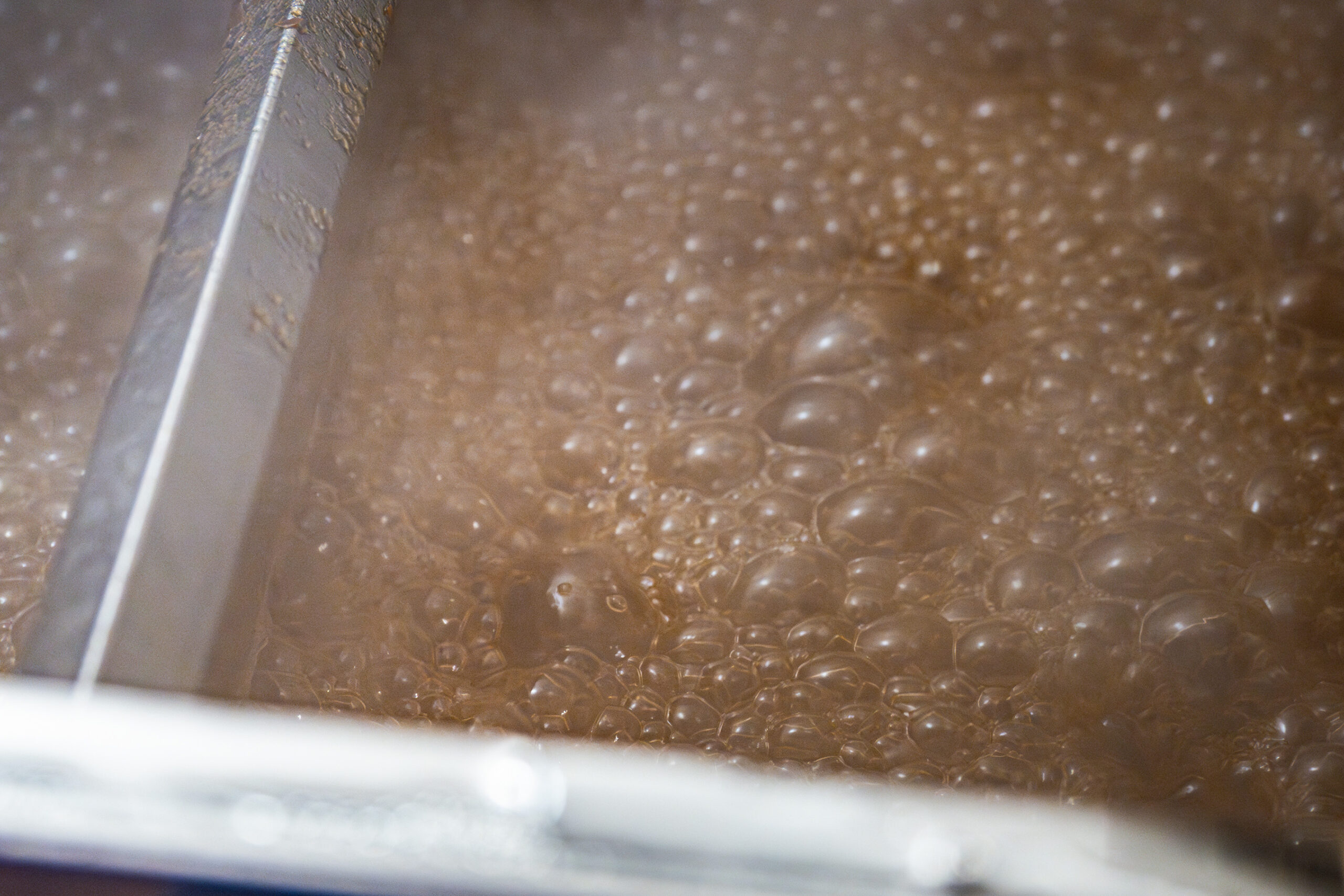 Sap reaches its boiling point at roughly 219 degrees. In the evaporator, producers can tell when it's ready after it transforms to its distinct amber coloring.