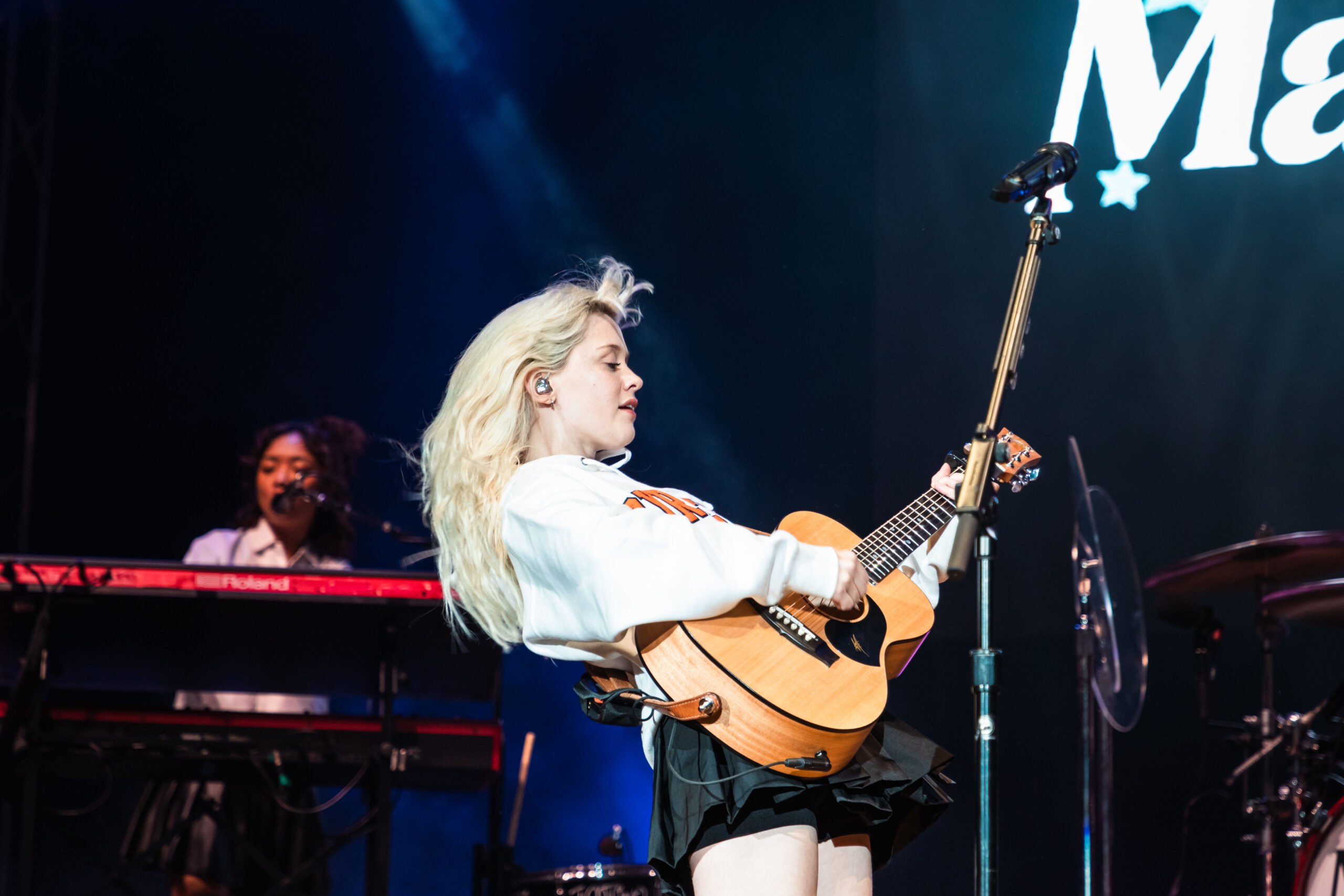 As she sways backward, Maisie Peters’ bangs fly up into the air. Peters played her own guitar during her set. 