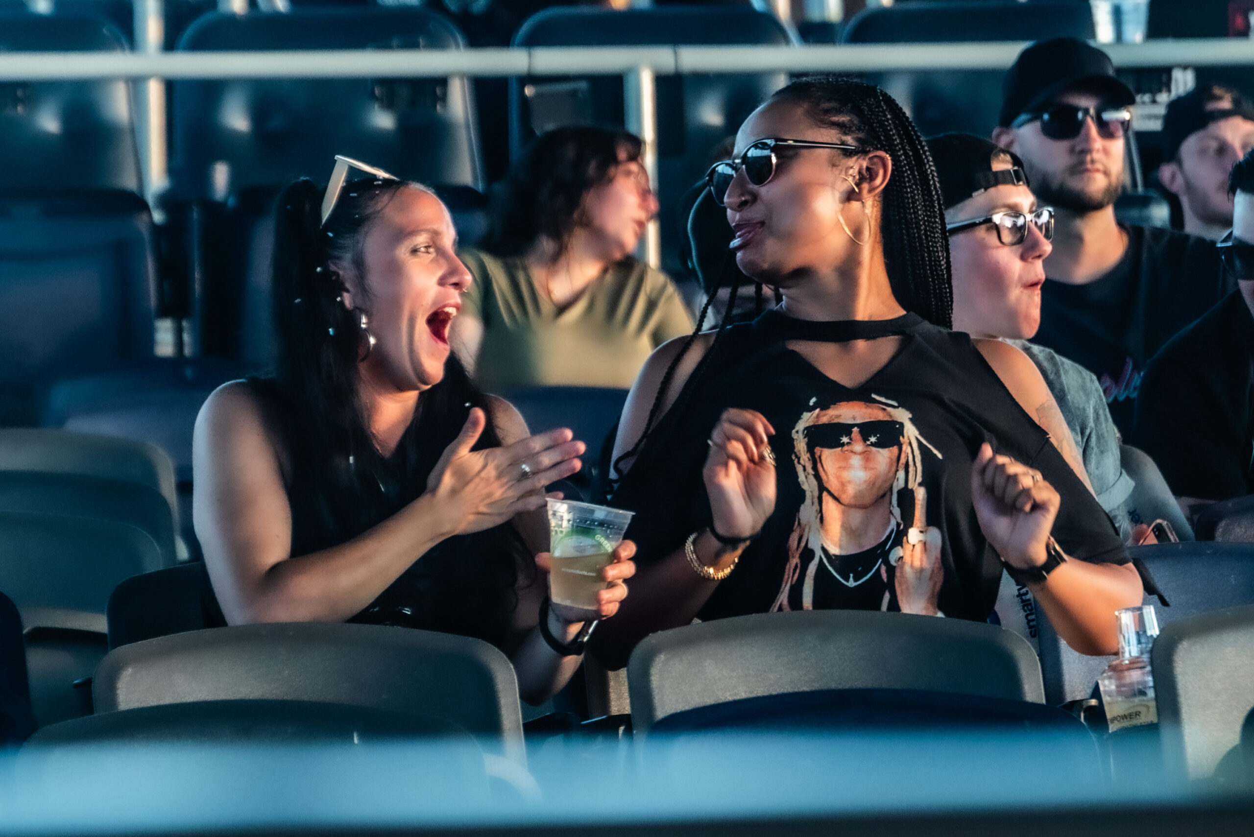 Lil Wayne fans await the Young Money rapper’s arrival. Though he was nearly an hour late to the show, fans were excited, dubbing graphic T-shirts and sunglasses. 