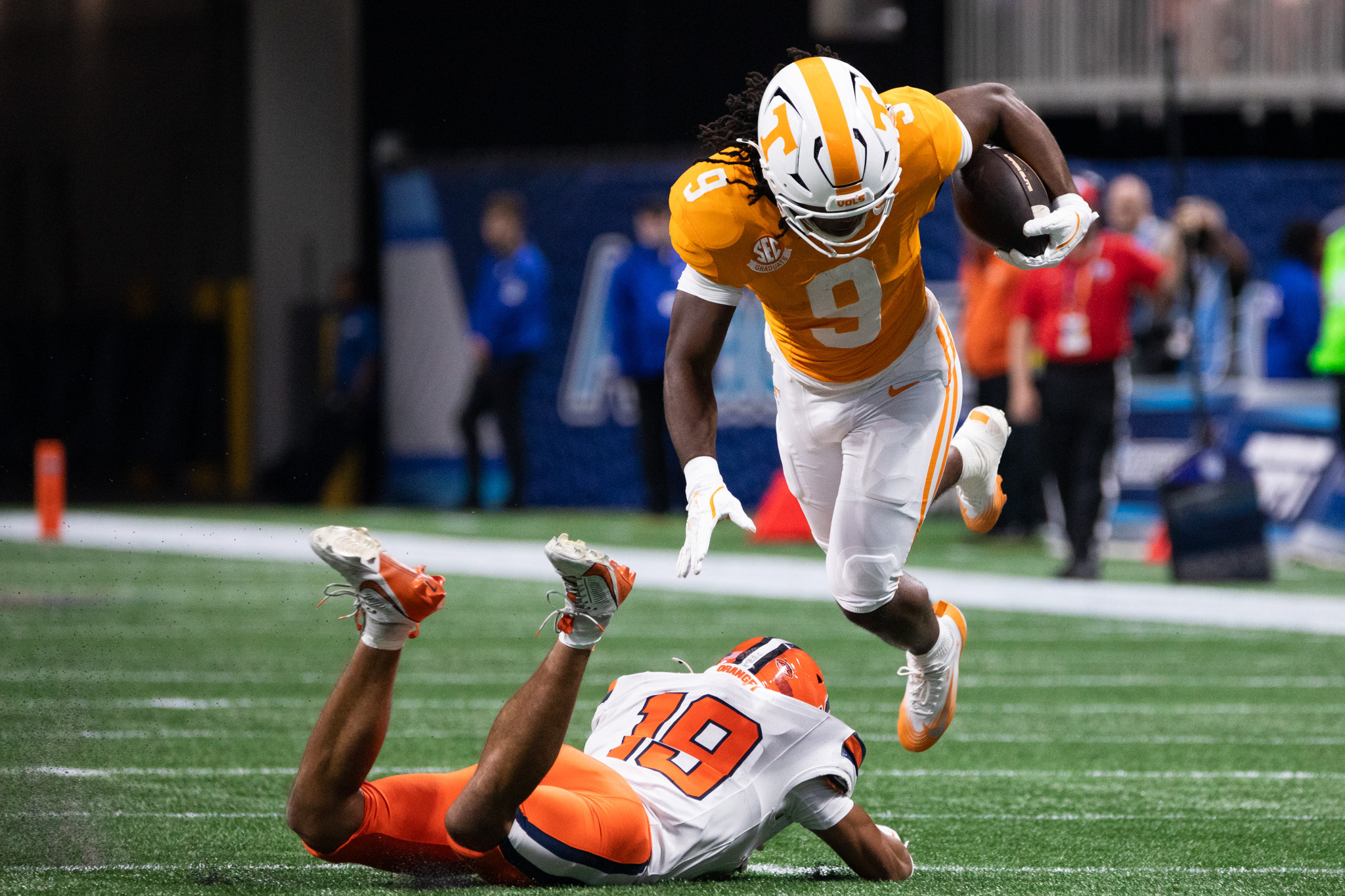 Volunteer running back Star Thomas leaps over the outstretched arms of Syracuse defensive back Cornell Perry. Thomas was Tennessee’s leading rusher against SU, pacing the Volunteers with 92 rushing yards.