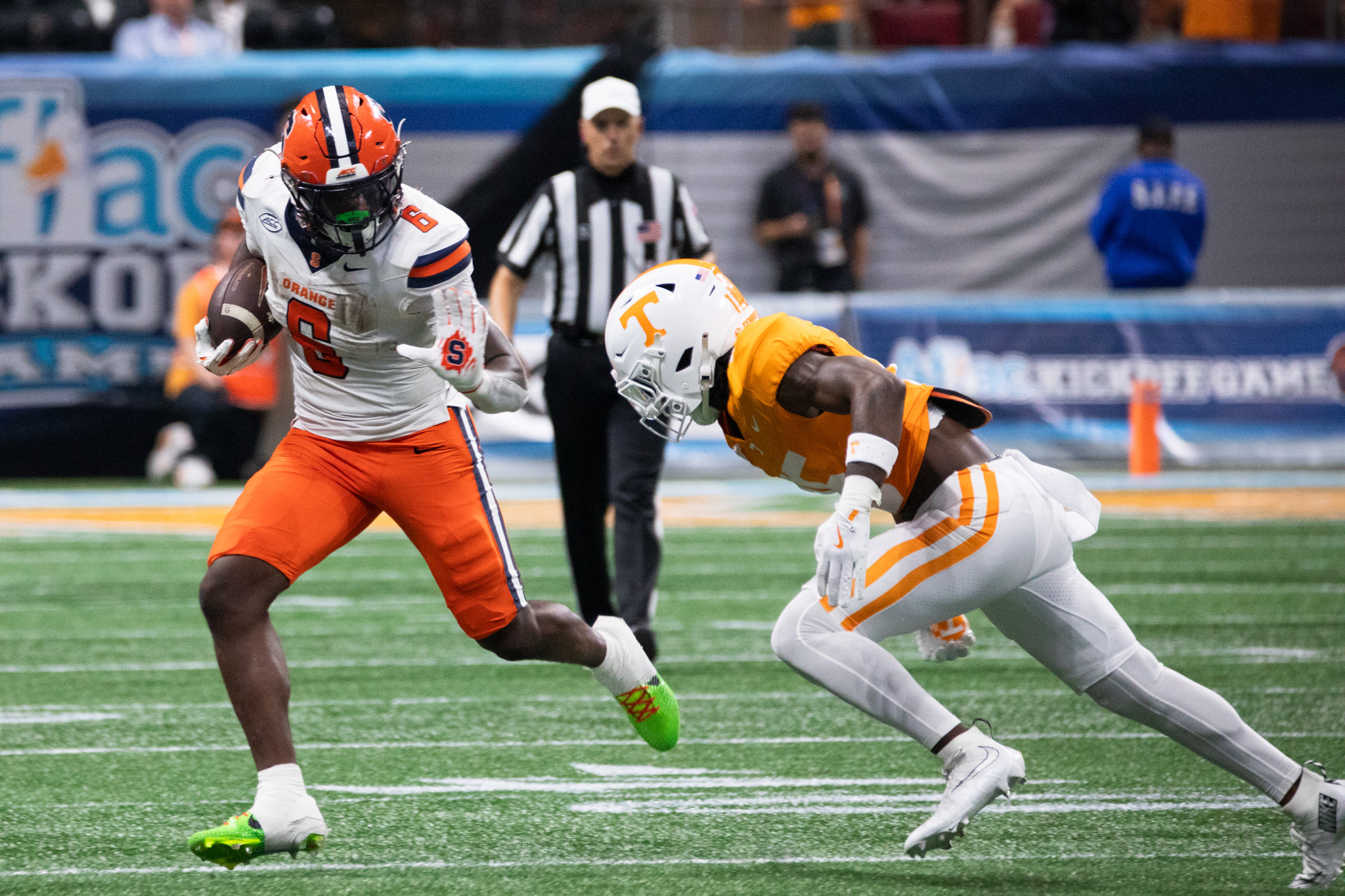 Syracuse running back Yasin Willis prepares to stiff arm Tennessee defensive back Edrees Farooq. Willis led the Orange with three rushing touchdowns against the Volunteers.
