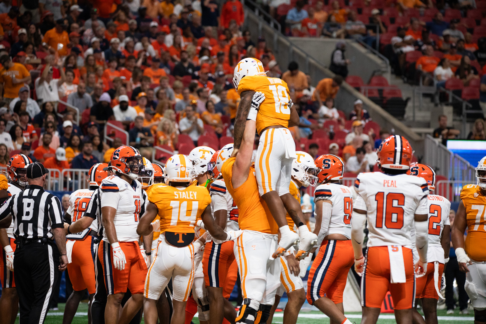 A Tennessee offensive lineman lifts Volunteer running back DeSean Bishop into the air after his second-quarter rushing touchdown. Bishop ranked second among the Vols with 82 rushing yards against the Orange. 