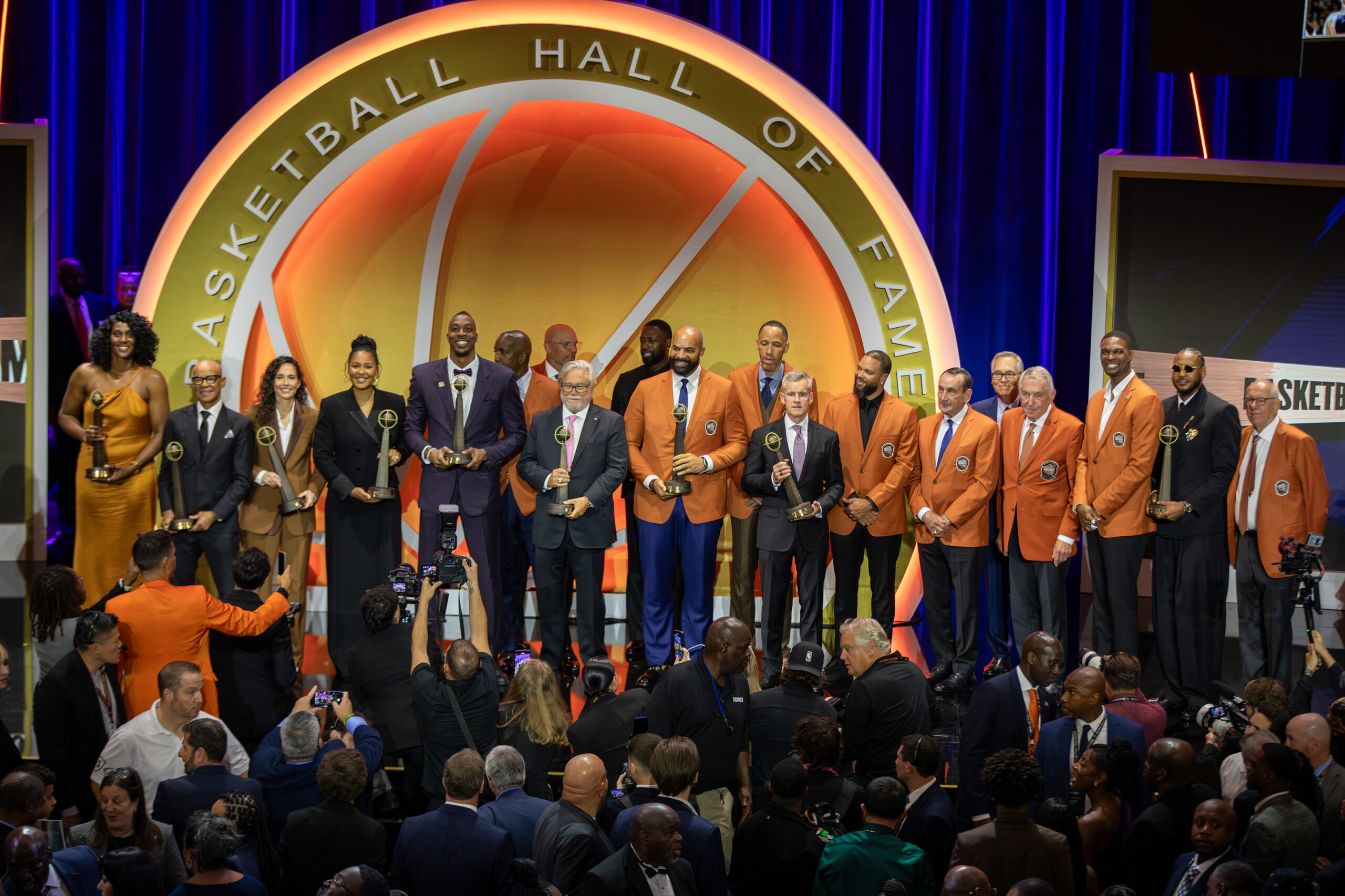 Boeheim (far right) and Anthony (next to Boeheim) stand together as the Hall of Fame’s 2025 class poses on the stage in Symphony Hall to conclude the ceremony. Before his induction, Anthony said, “If you’re talking about someone who is an advocate for Carmelo Anthony, it’s Jim Boeheim.”