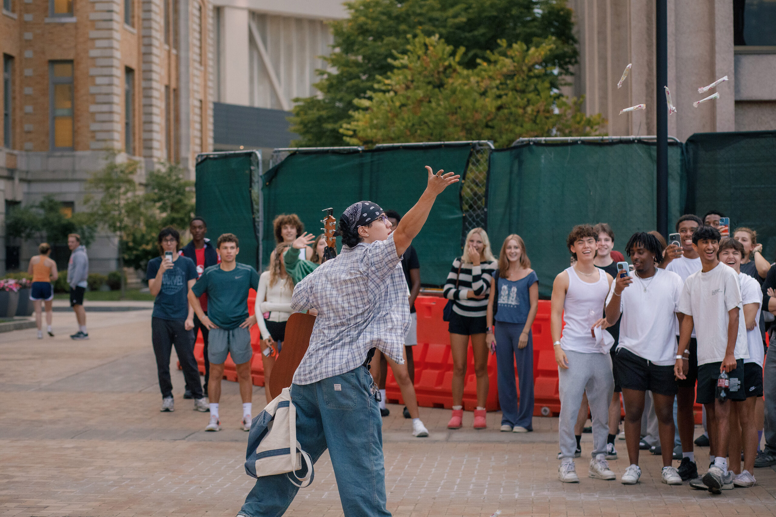 A contestant throws tampons into the audience to gain favor during voting. On Saturday evening, crowds gathered outside of Carnegie Library to observe a “performative male” competition.