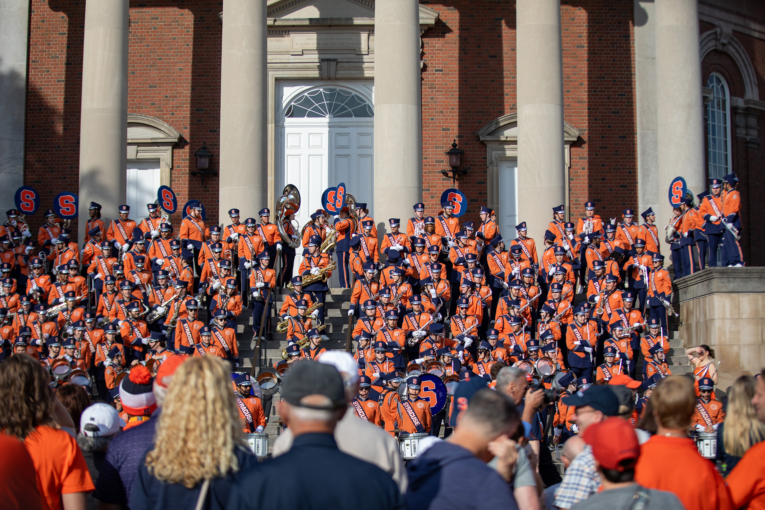 Hundreds of fans, students and parents wait for the Orange to arrive. Spectators listened to the band as they played music from the steps of Hendricks Chapel both before and during the team’s walkout.