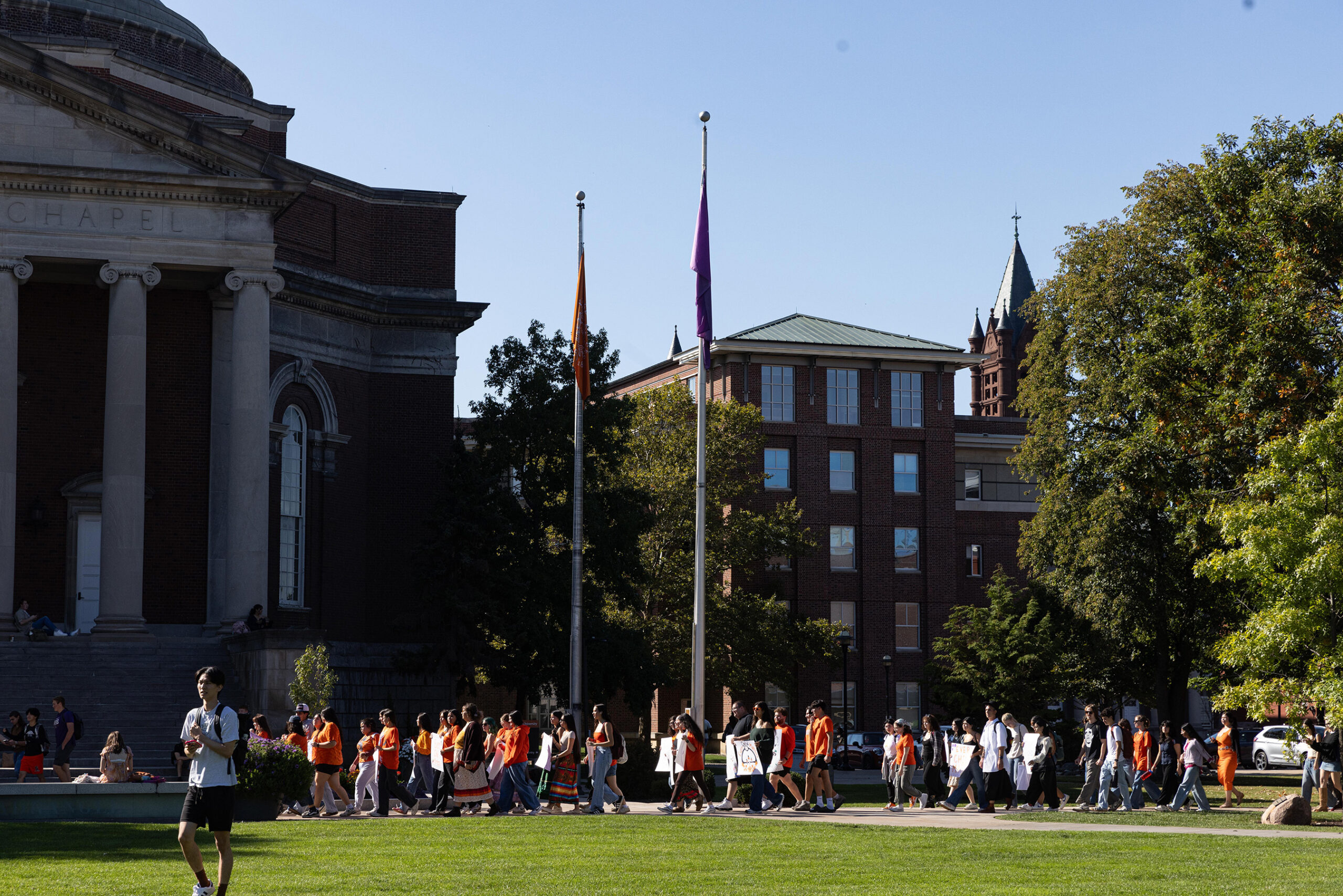 The group passes by SU’s Hendricks Chapel before beginning its last leg around the Shaw Quadrangle. Demonstrators started at 113 Euclid Avenue, walked past College Place and traced the perimeter of the Quad.
