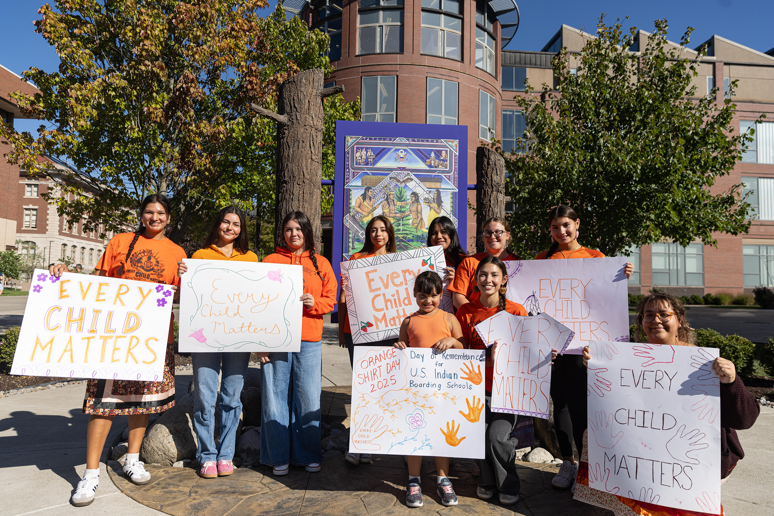 Lylla Schindler, President of Indigenous Students at Syracuse (far left), alongside other members of the organization. The 20-minute walk concluded with a moment of silence around “Gayaneñhsä•ʔgo•nah” (which translates to “the Great Law of Peace”), a painting done by Brandon “Ganyada•kda” Lazore, Onondaga Nation, snipe clan.