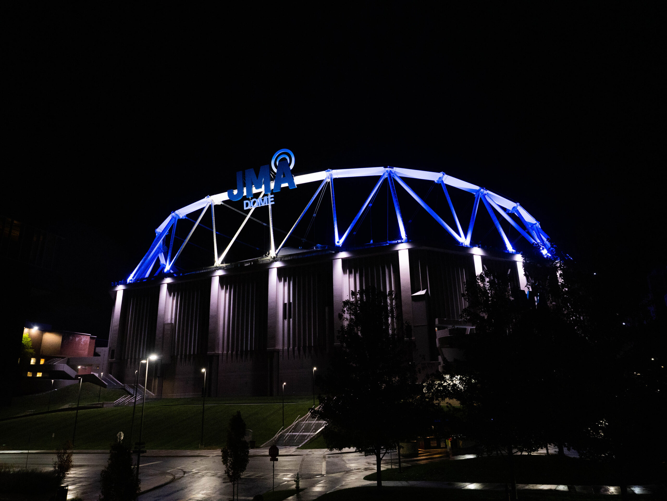 Throughout the week, the JMA Wireless Dome and Hall of Languages are lit in blue and white to commemorate Remembrance Week, alongside blue and white flags throughout campus.