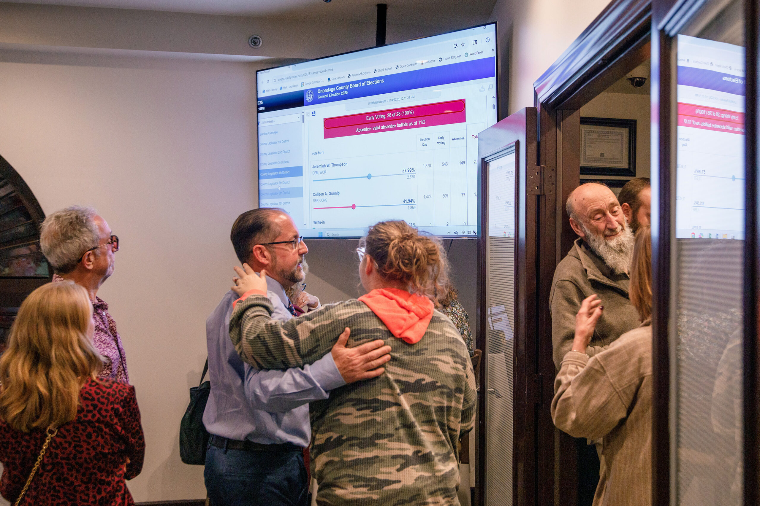 Republican candidate Thomas Babilon embraces his daughter as poll results emerge. Surrounded by his supporters, other Republican candidates and colleagues, Babilon celebrated his campaign journey at his Tuesday night watch party. 
