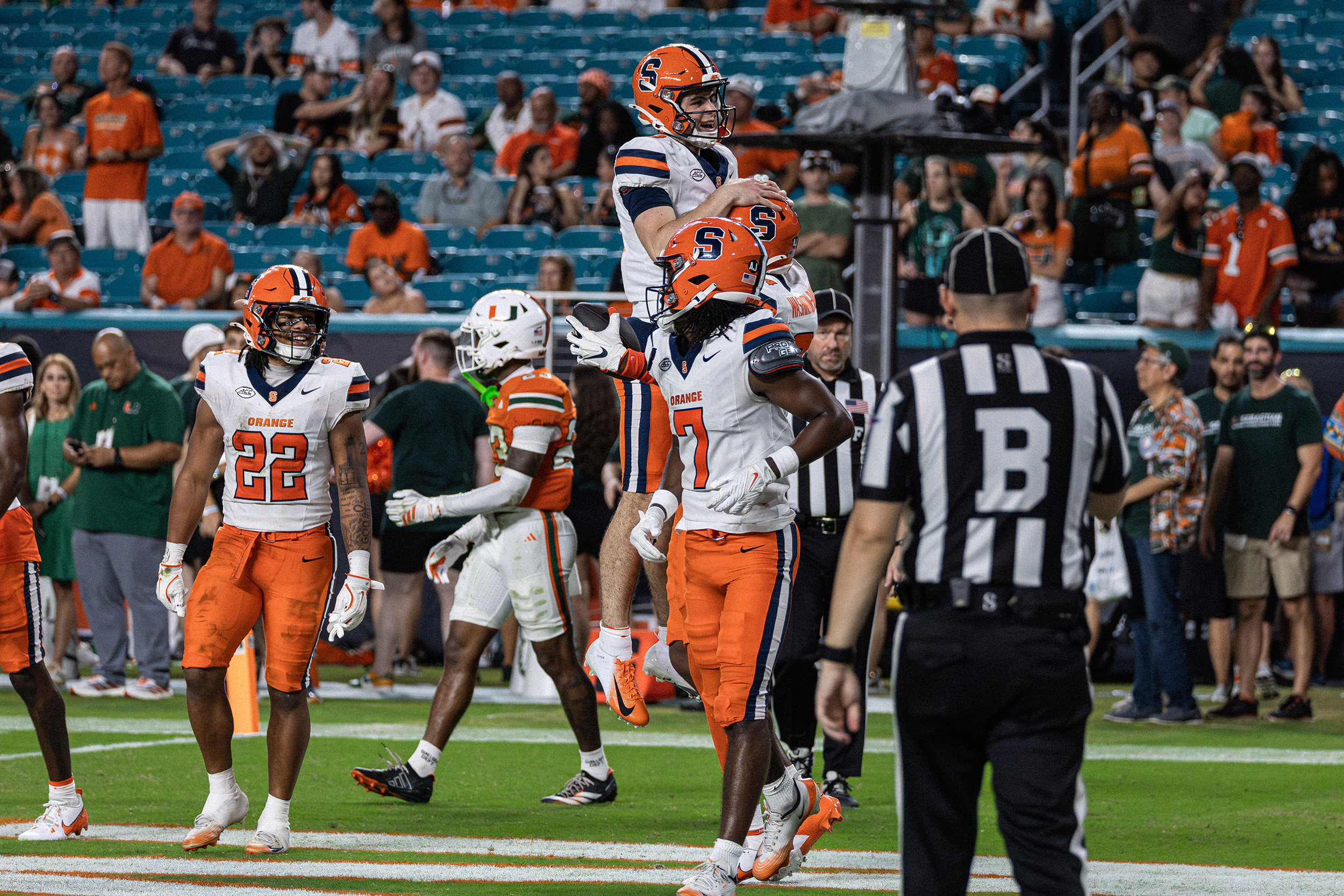 Syracuse tight end Elijah Washington-Baker lifts Filardi to celebrate his 17-yard fourth-quarter touchdown reception. With the grab, Washington-Baker secured both his first career catch and touchdown.