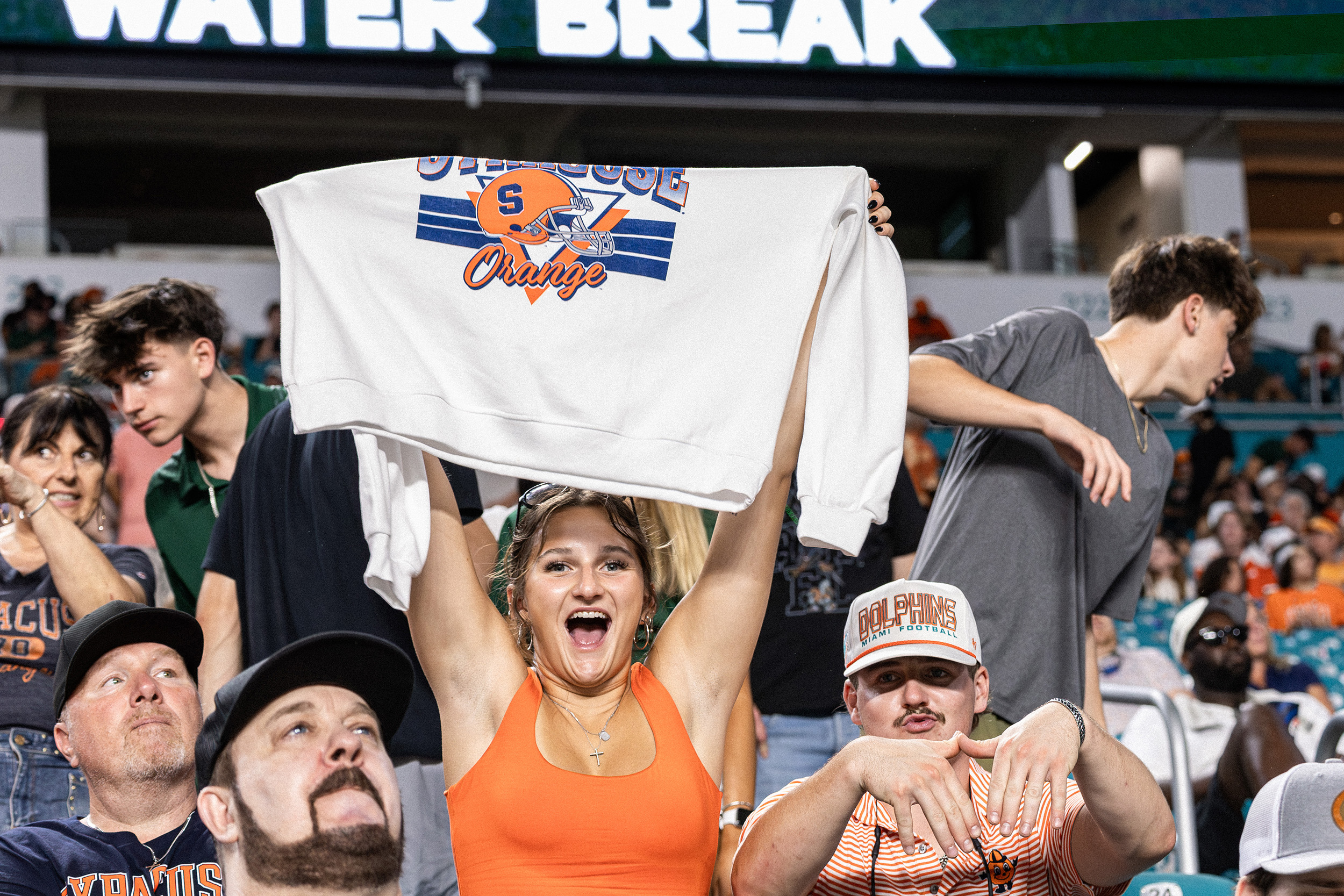 Two Syracuse fans proudly show off their SU merchandise. The Orange traveled over 1,400 miles to face Miami, their second-longest trip of the season.