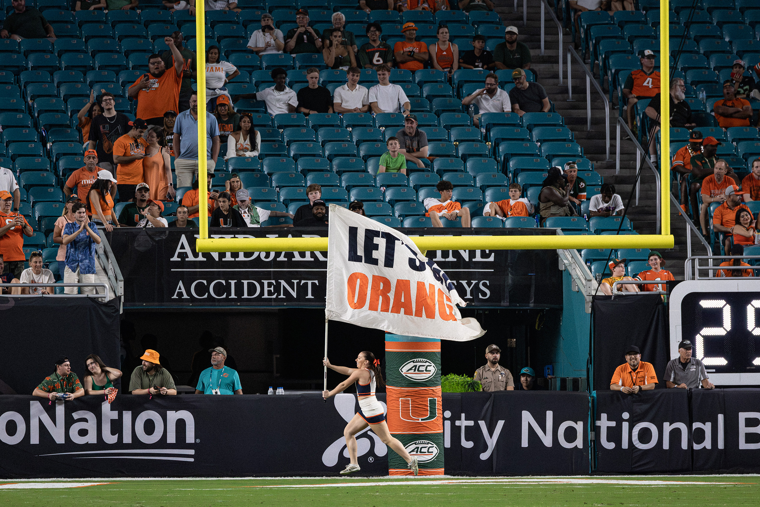 A Syracuse cheerleader sprints across the endzone, holding a “Let’s Go Orange” banner. Miami found the end zone five separate times in its 38-10 victory over Syracuse Saturday.
