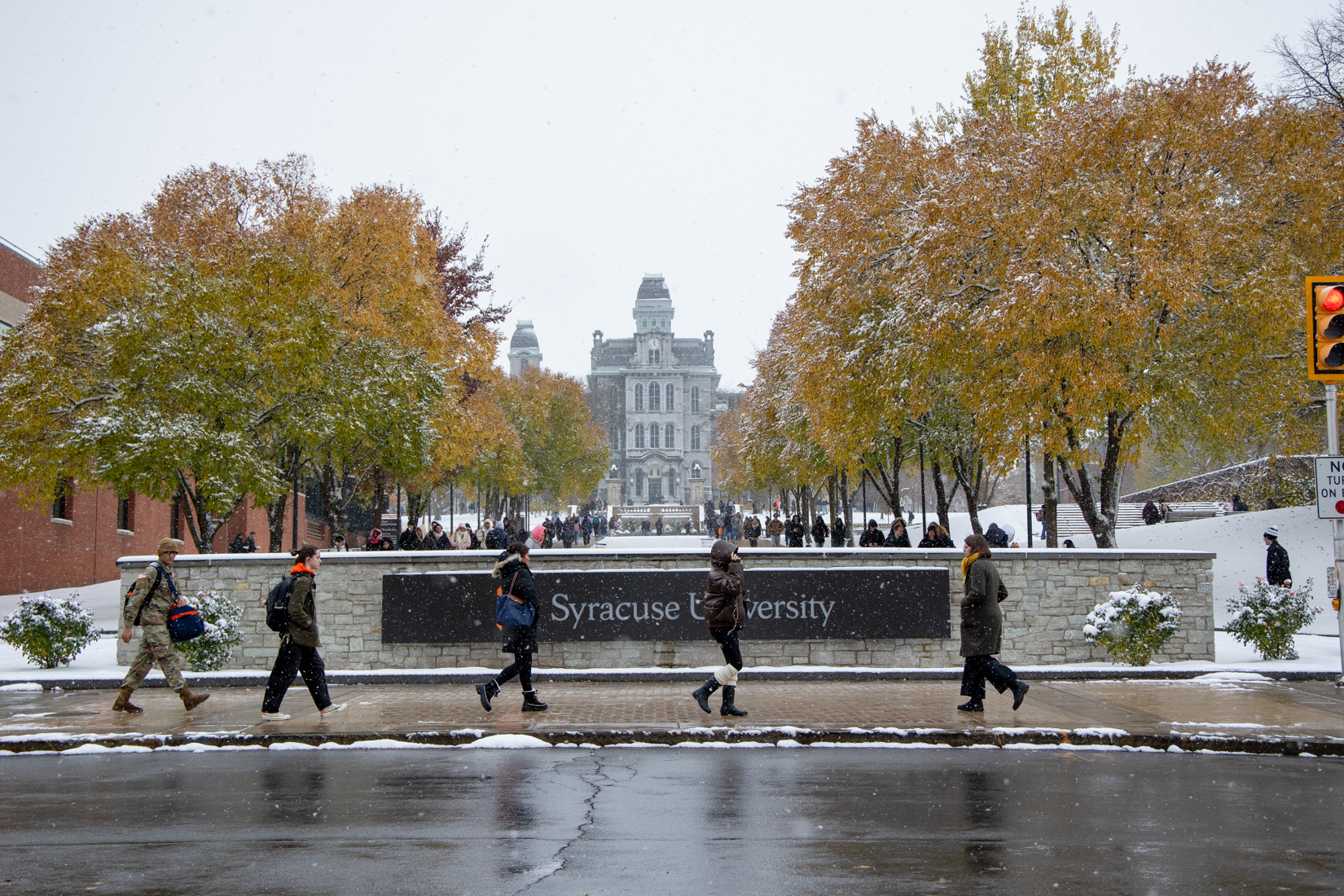 Students bundle up as they walk to class in the cold, snowy weather. On Tuesday, the low was 26 and the high was 35. 