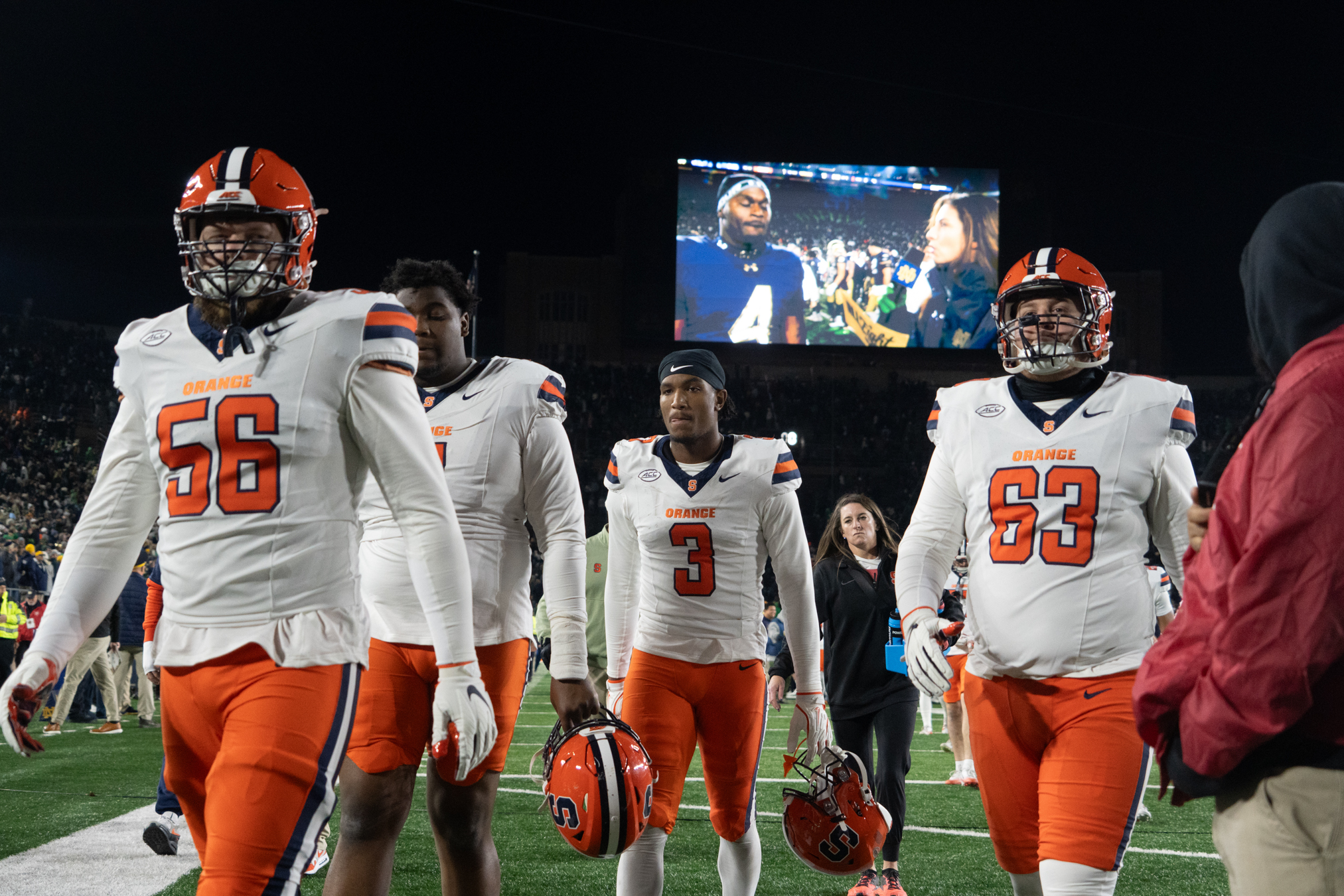 A group of Syracuse players walks off the field following its historic 70-7 loss. The Orange’s offense recorded just 207 yards, while their defense allowed seven touchdowns and nearly 400 yards on Saturday.