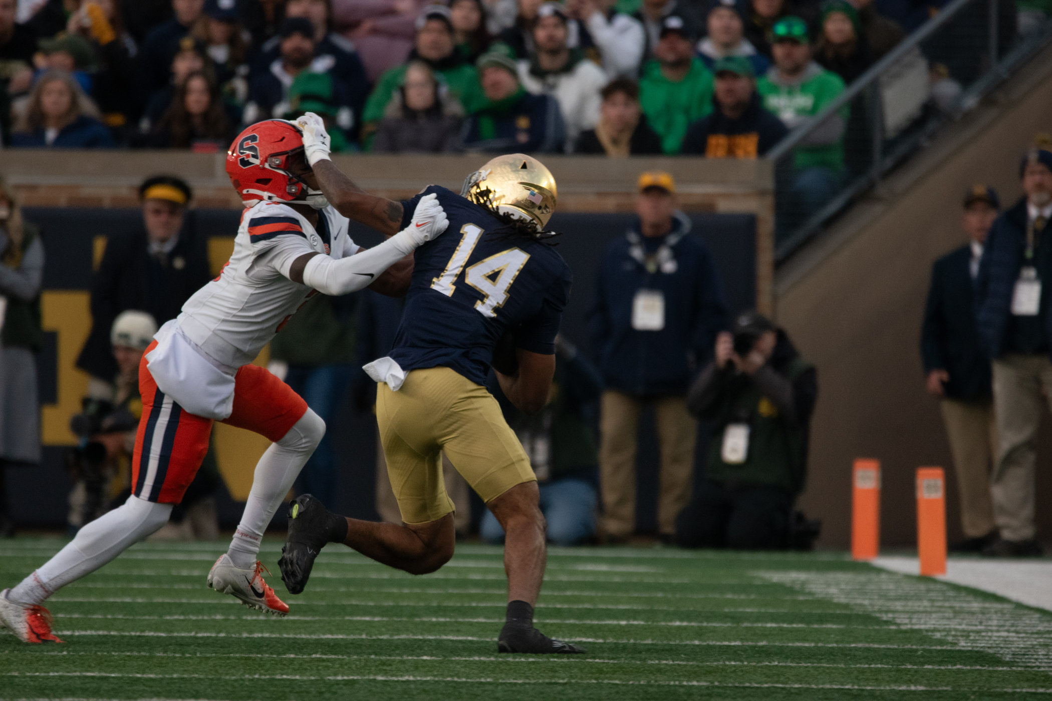Notre Dame wide receiver Micah Gilbert stiff-arms a Syracuse defender. Gilbert’s 10 yards were part of a quiet day for the Fighting Irish’s air attack, as they relied mostly on their ground game and defense.