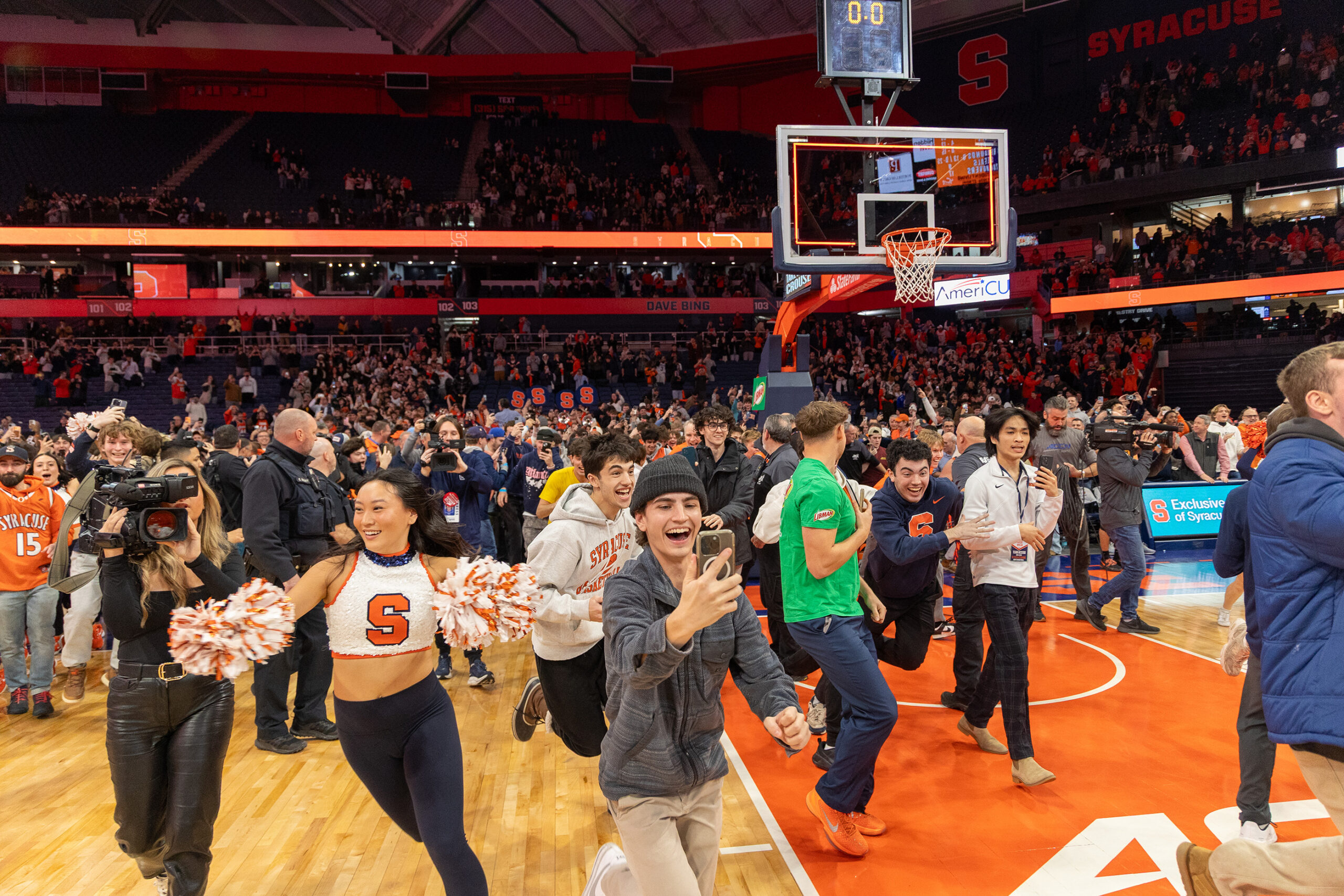 Fans rush the court after Syracuse Men’s Basketball’s upset win against No. 13 Tennessee Tuesday night. This was the Orange’s first Quad 1 win of the season, after dropping three games in Las Vegas.