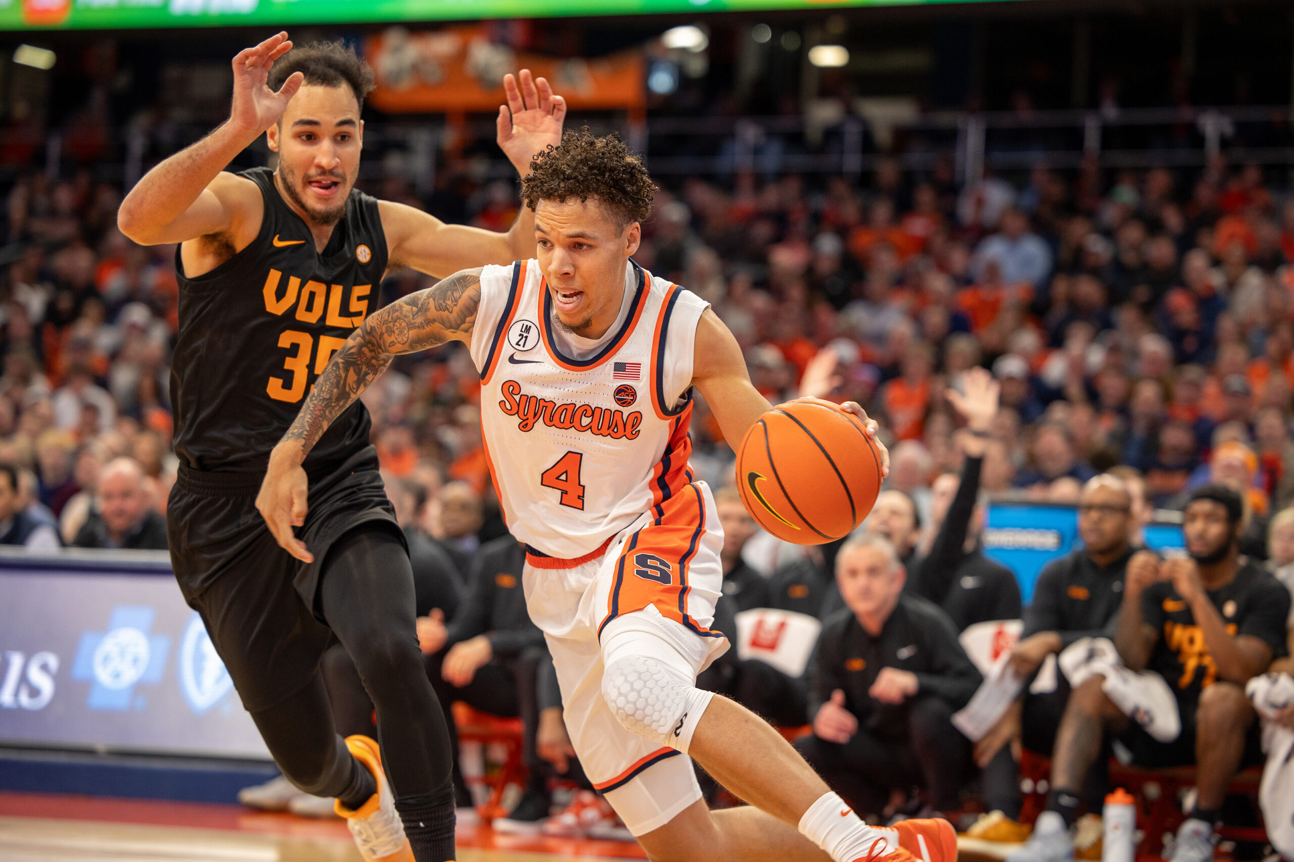 Syracuse guard Nate Kingz dribbles around Tennessee guard Ethan Burg. Kingz didn’t shoot once in the second half, but he still led the way for the Orange with 19 points and added seven rebounds. 