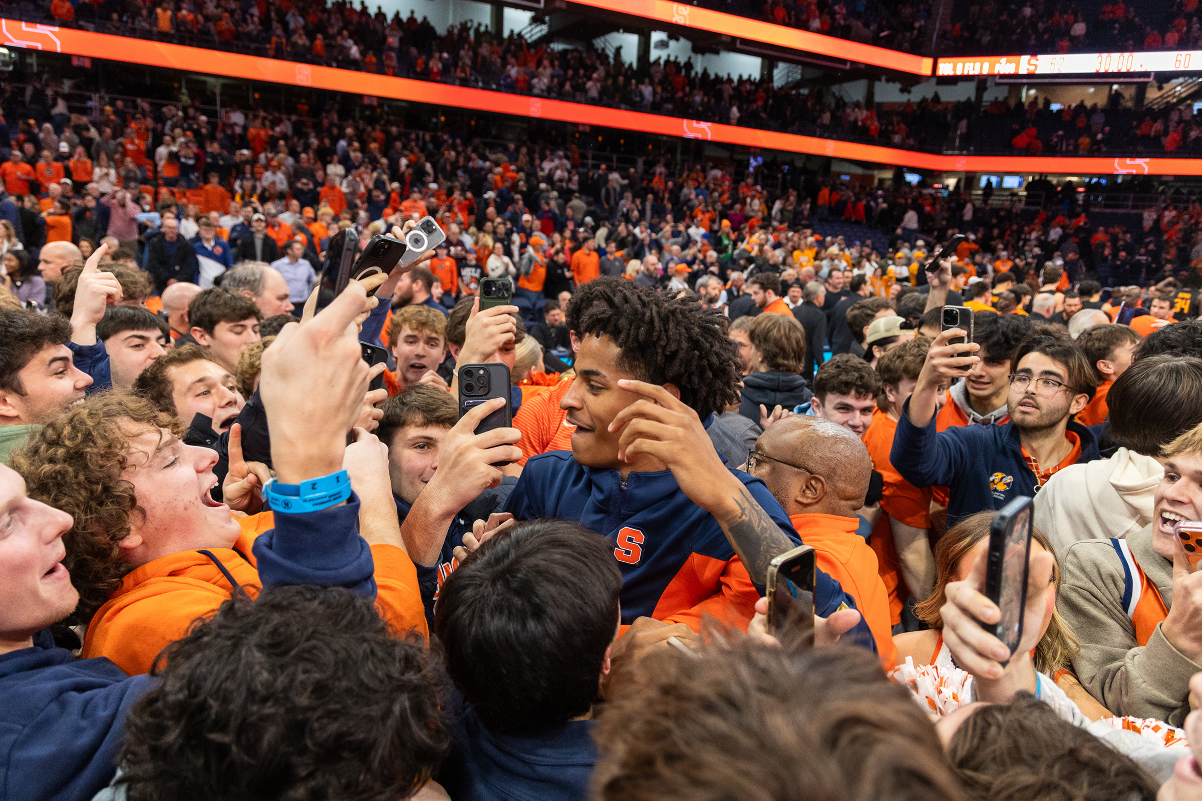 December: Fans storm the court after Syracuse men’s basketball’s upset win against No. 13 Tennessee. The win was the Orange’s first Quad 1 win of the season, a needed result after dropping a trio of matches in Las Vegas the week prior.