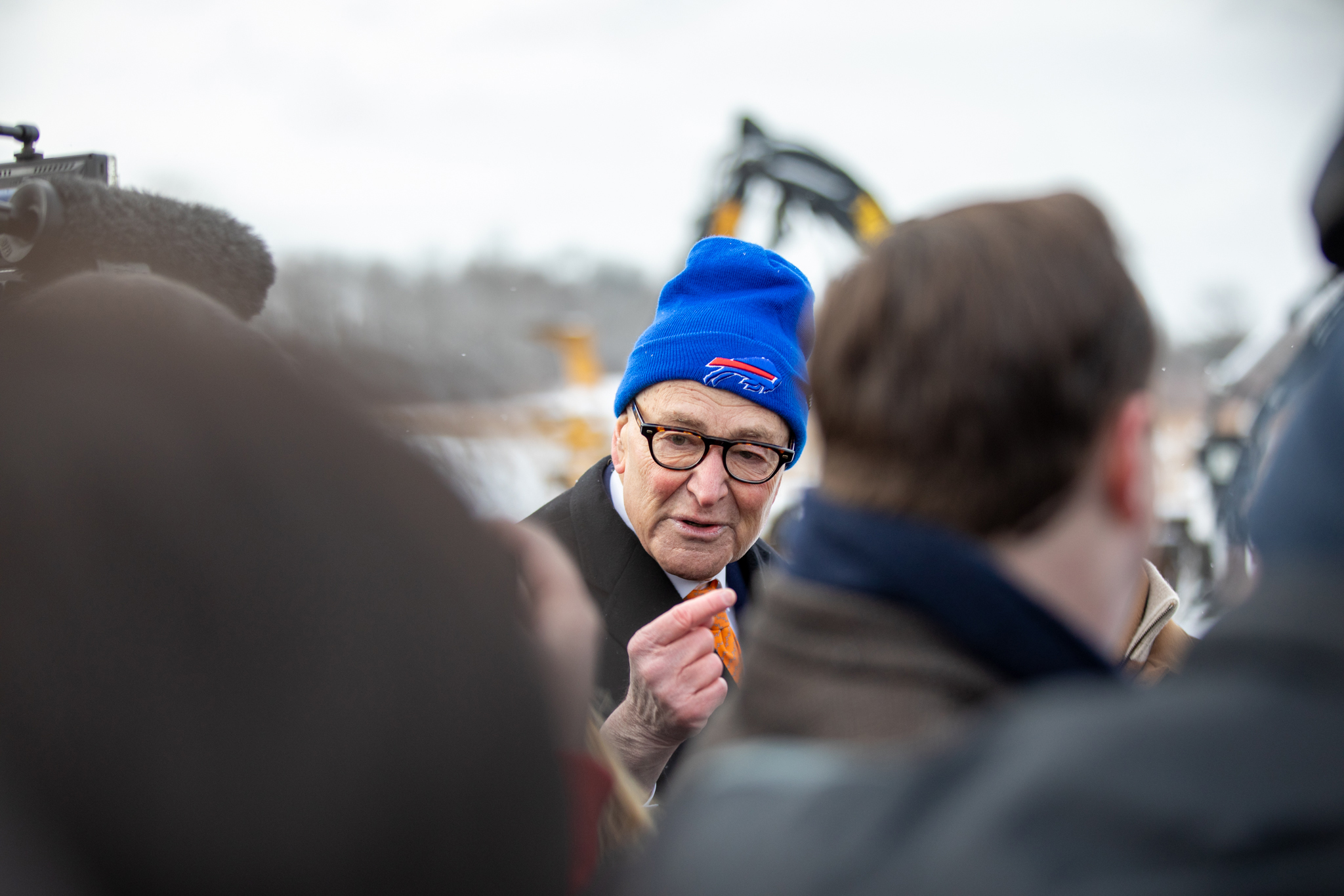 U.S. Sen. Chuck Schumer mingles with reporters and attendees at Micron’s groundbreaking. Schumer, who often begins remarks with “Go Bills,” sported a Buffalo Bills hat a day before the Bill’s playoff exit against the Denver Broncos.