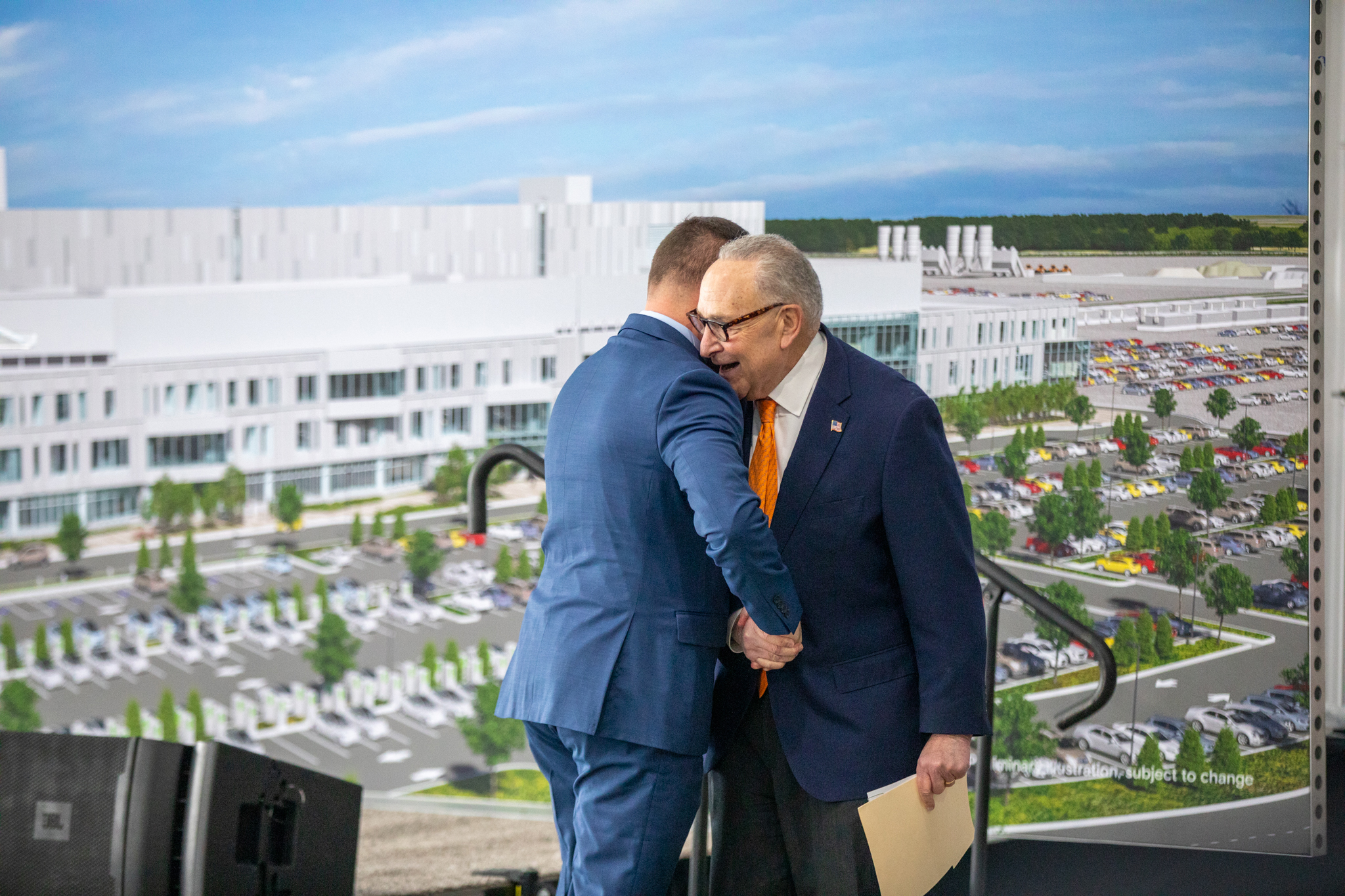 Chuck Schumer, the Democratic Senate leader, embraces Republican Ryan McMahon, the current county executive for Onondaga County. Attendees on opposite sides of the political aisle disagreed on which presidential administration deserves the credit for Micron’s groundbreaking.