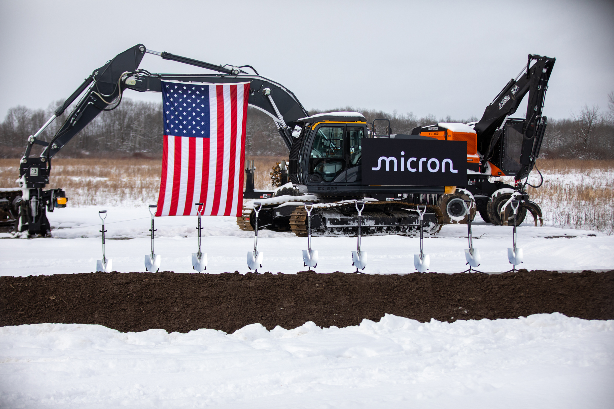 A still image of the spot on which Micron marked its Clay, New York, groundbreaking the same day groups in opposition sued to challenge its environmental approval. The U.S. flag alongside the company’s logo represents what attendees argued is a major win for a fleeting American manufacturing industry.