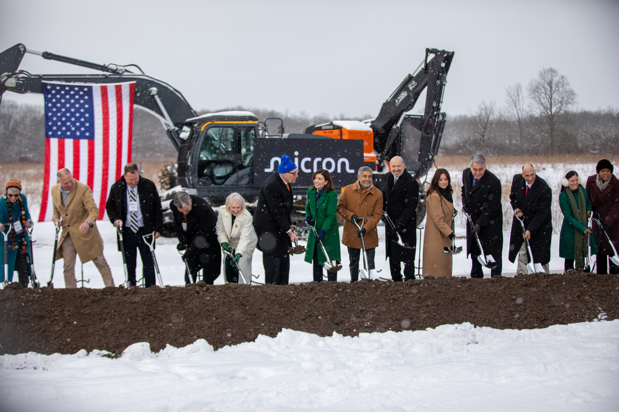 An assembly line of elected officials and leaders ceremoniously mark Micron’s groundbreaking with shovels. State leaders present included Syracuse Mayor Sharon Owens, both New York senators and Gov. Kathy Hochul.