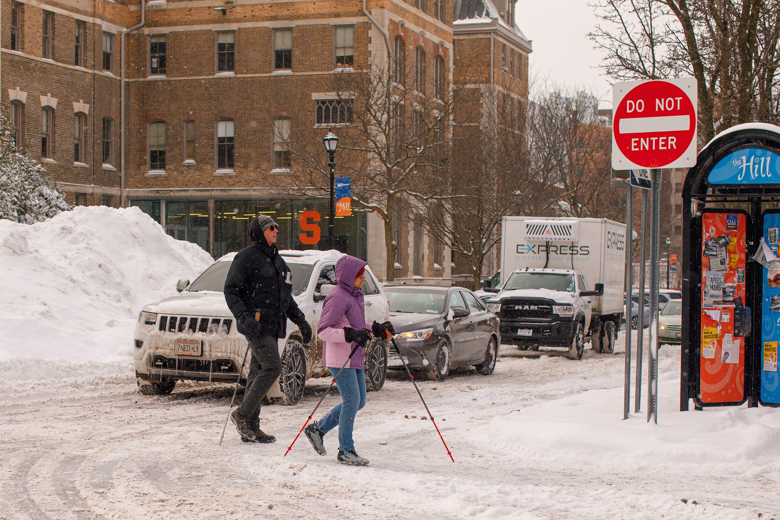 Syracuse pedestrians bundle up and practice caution as they walk across Marshall Street. People flocked to Marshall Street for food.
