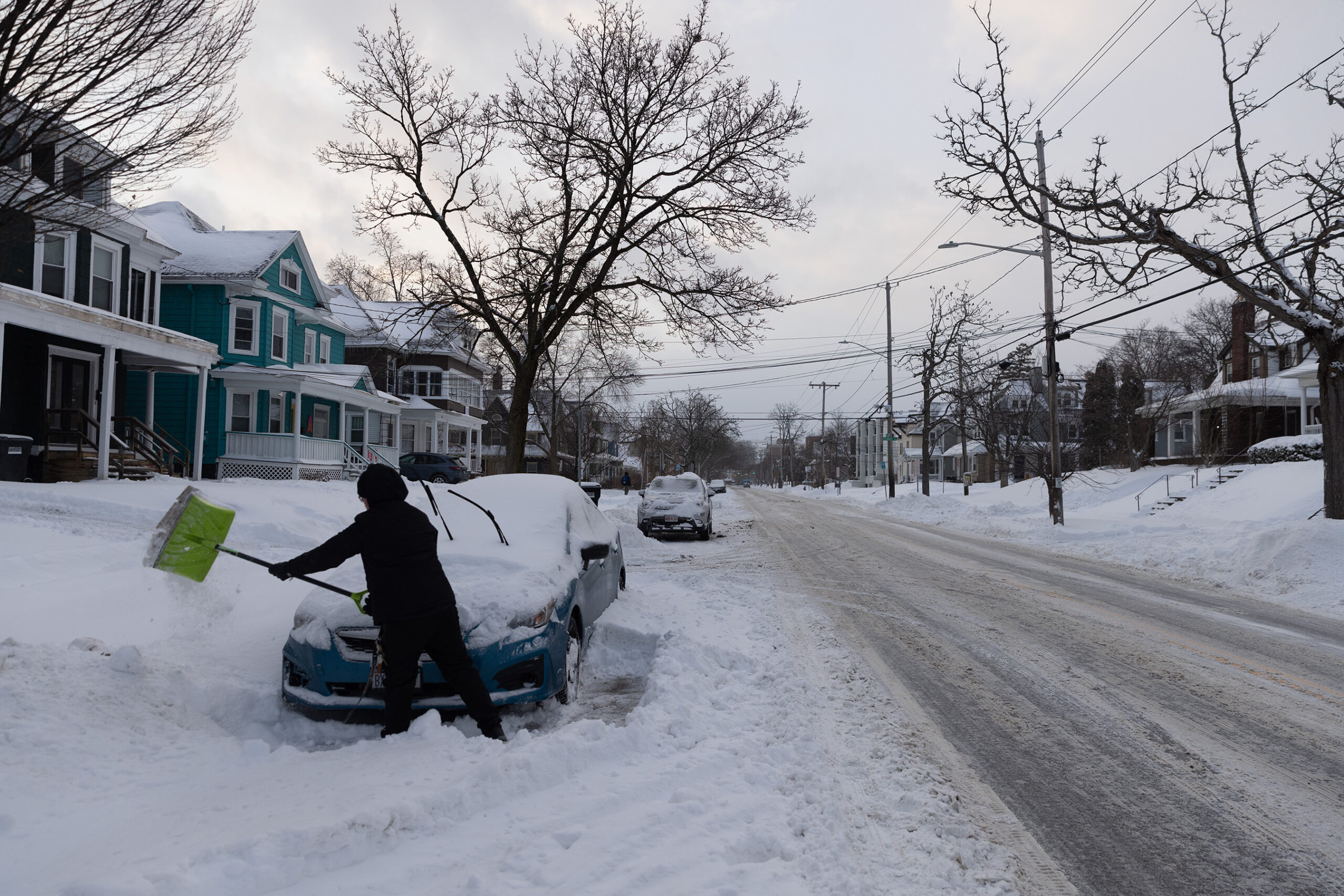 A University Neighborhood  resident shovels their car out of the snow early Monday morning. Syracuse received almost eight inches of snow Sunday night.