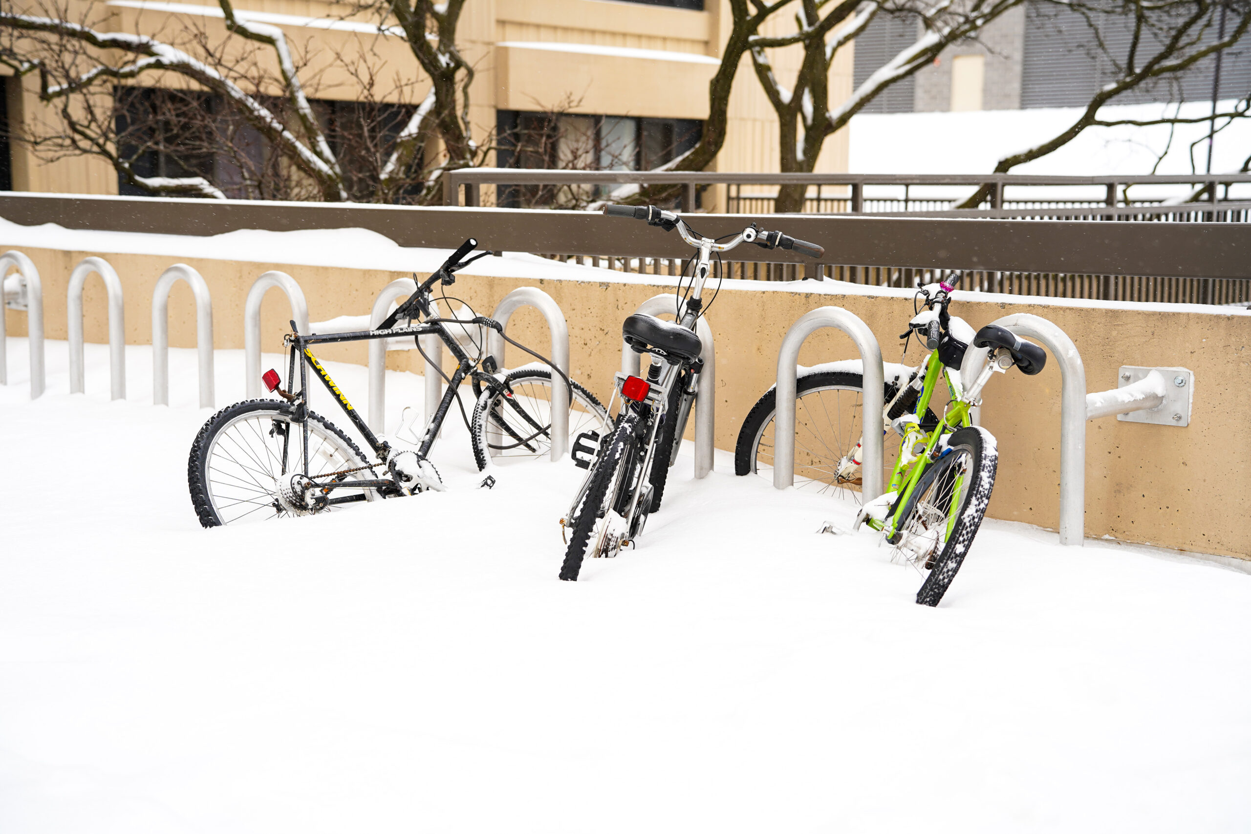 Student bicycles buried in snow at the Brewster, Boland and Brockway halls complex. Syracuse closed Carnegie and Bird Library, while transportation remained operational throughout the day.