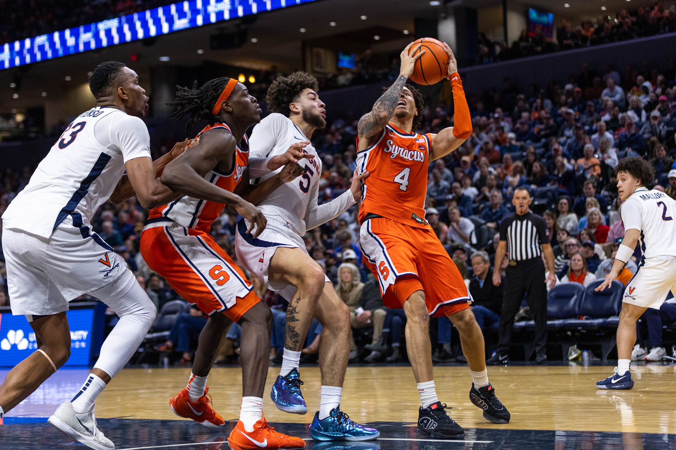 Nate Kingz attacks the paint against Virginia’s Sam Lewis. With 13 points, Kingz was one of three Syracuse players to score in double figures, but the Orange still fell by 13 points for their sixth loss in seven games.