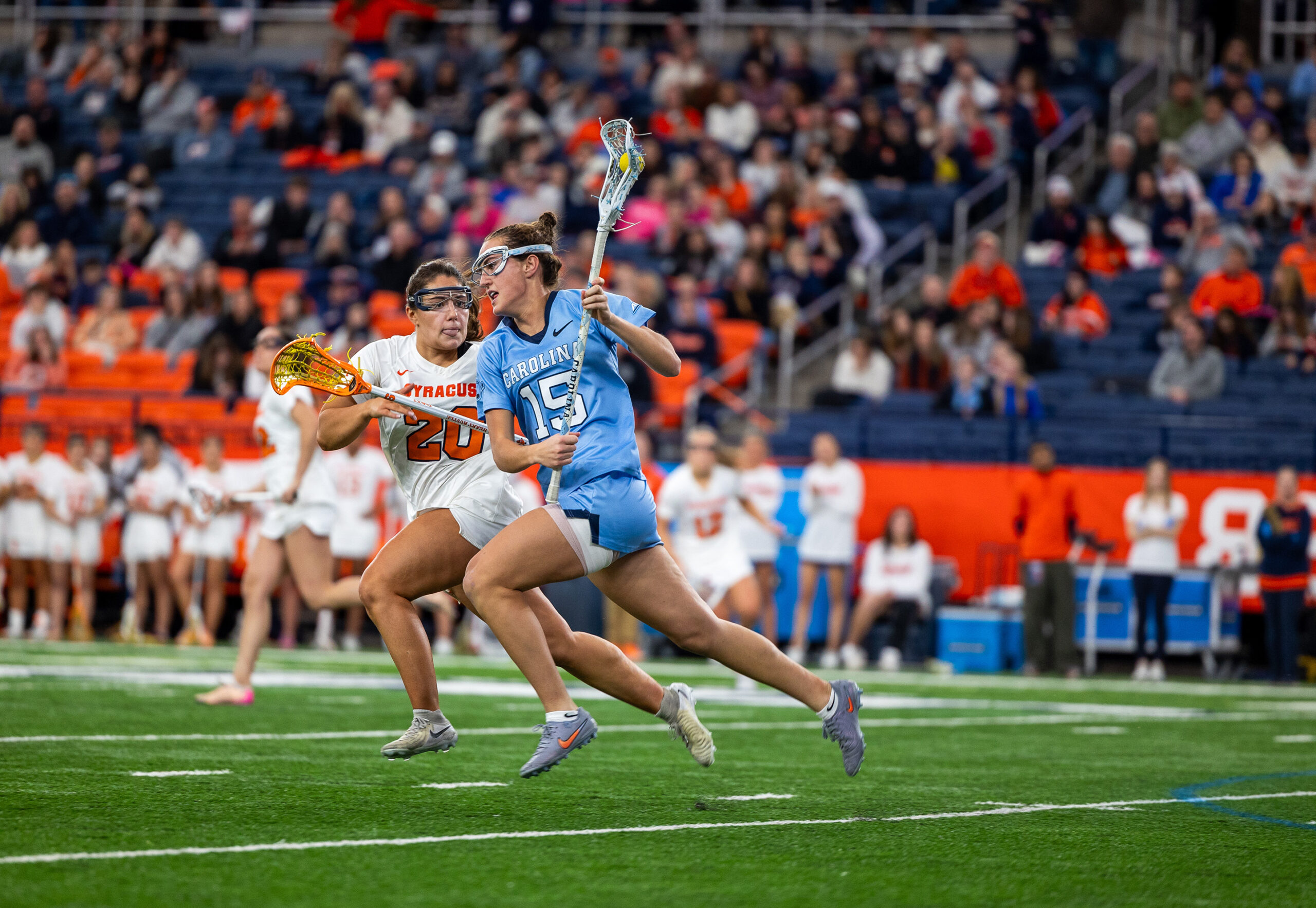 No. 1 North Carolina midfielder Eliza Osburn (15) runs with the ball while being guarded by No. 14 Syracuse’s Mackenzie Rich. The Tar Heels’ 5-2 fourth-quarter run allowed them to pull away from the Orange and secure the victory.