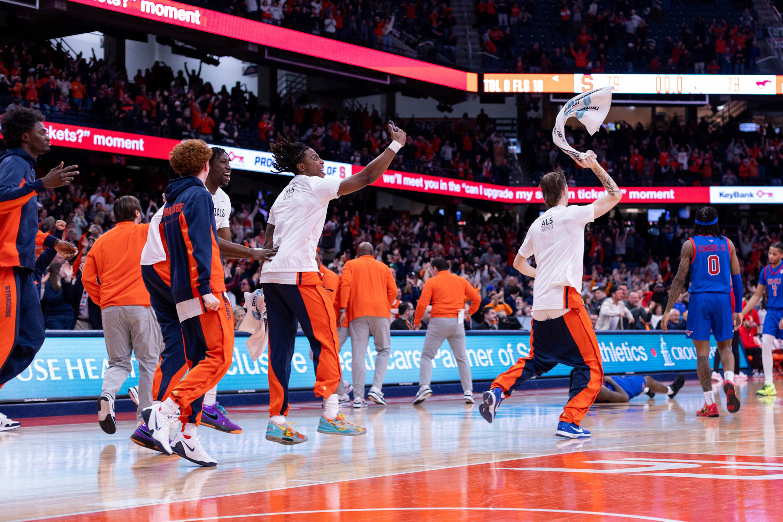 Syracuse men’s basketball’s bench jumped in celebration after the Orange came back to beat SMU 79-78 Saturday. SU trailed by as much as 12 points in the second half before storming back to overcome the Mustangs.