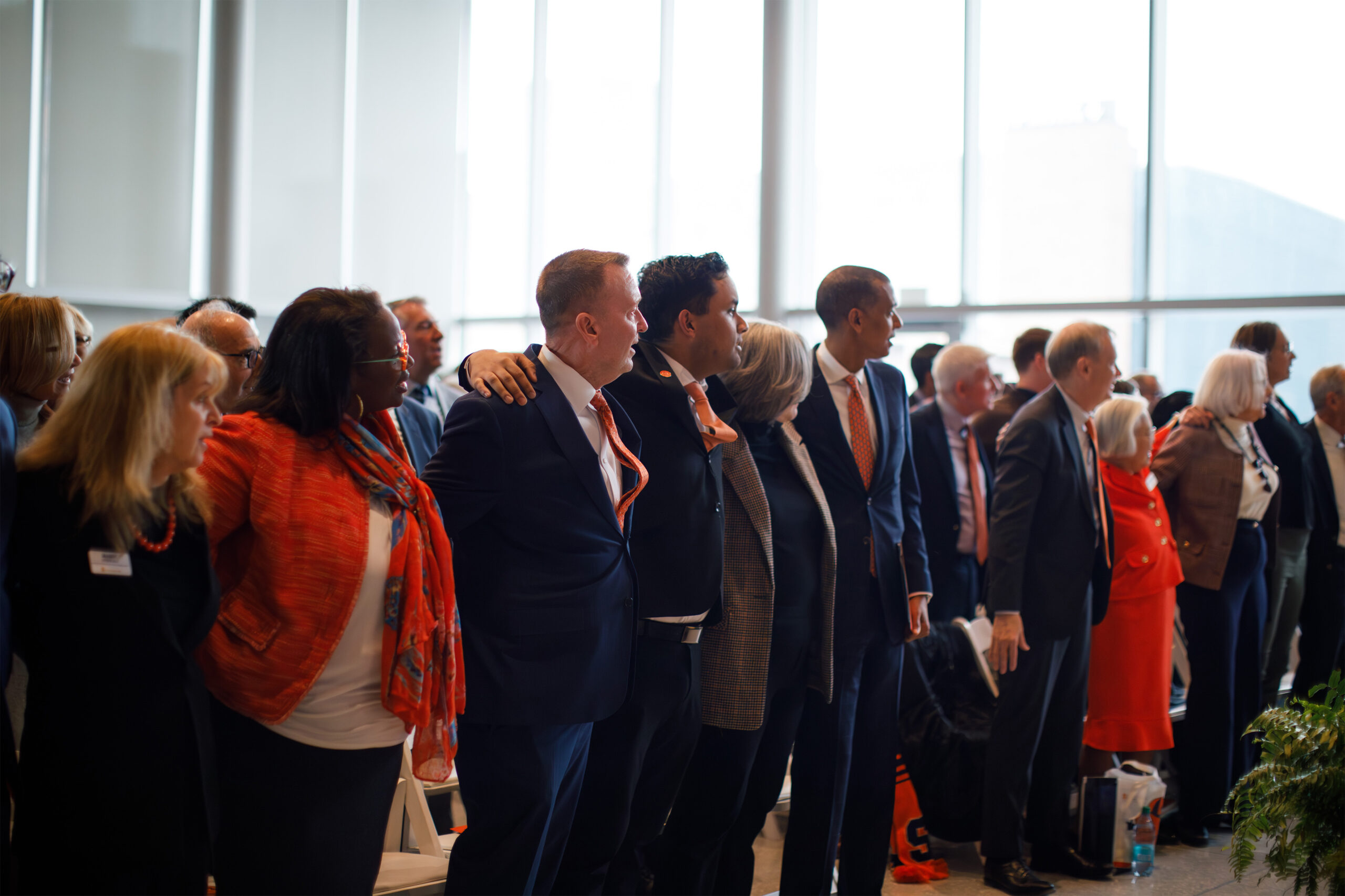 Audience members join arms as they are serenaded with SU’s alma mater, performed by University Singers. If the tie and the swaying are any indication, Chancellor-elect Mike Haynie bleeds orange.