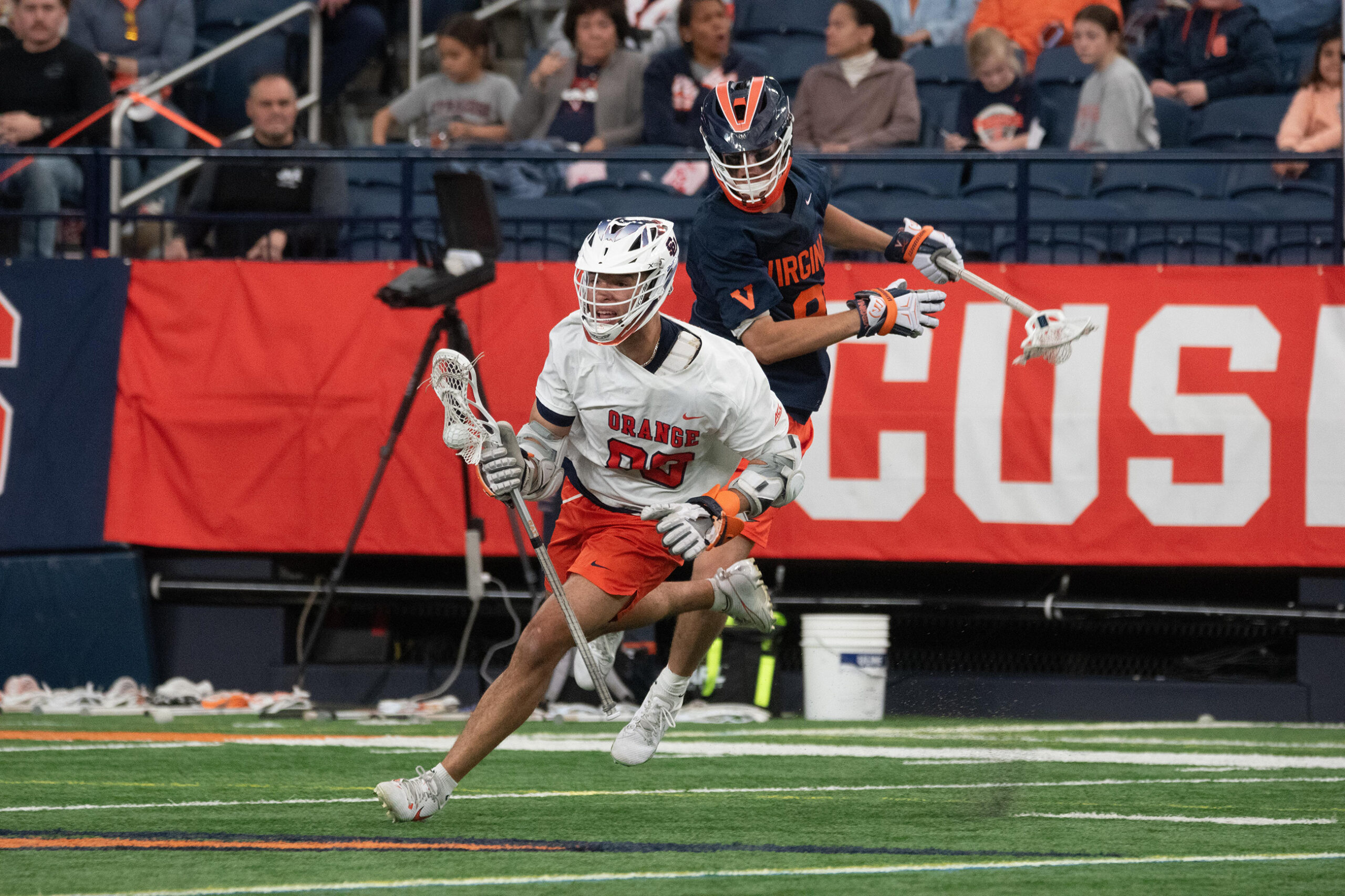 Syracuse midfield/attack Payton Anderson (white) dodges a Virginia defender in SU’s five-goal bounce-back win Saturday. Anderson notched one goal in the Orange’s triumph.
