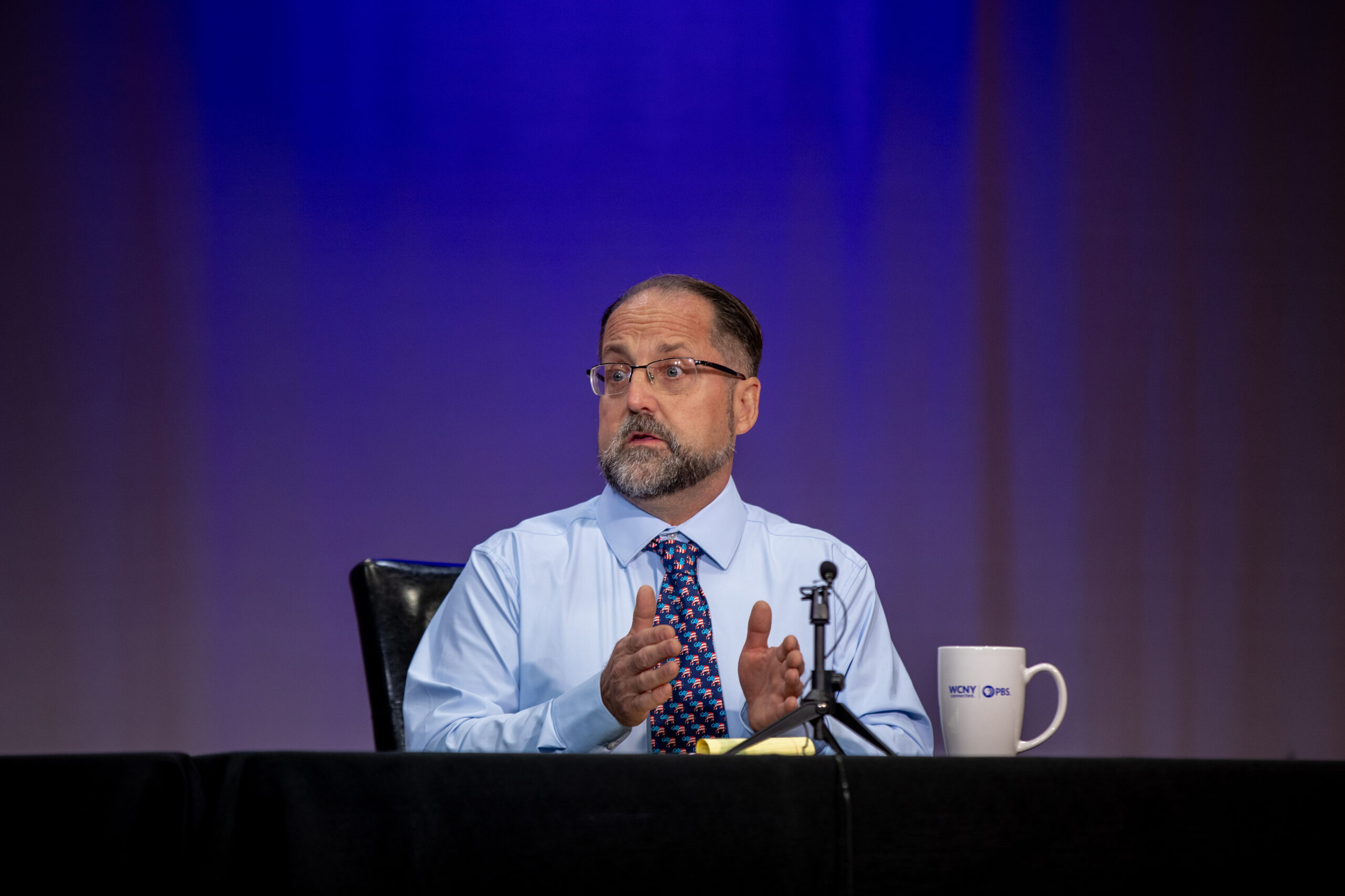 tom babilon sits at a table