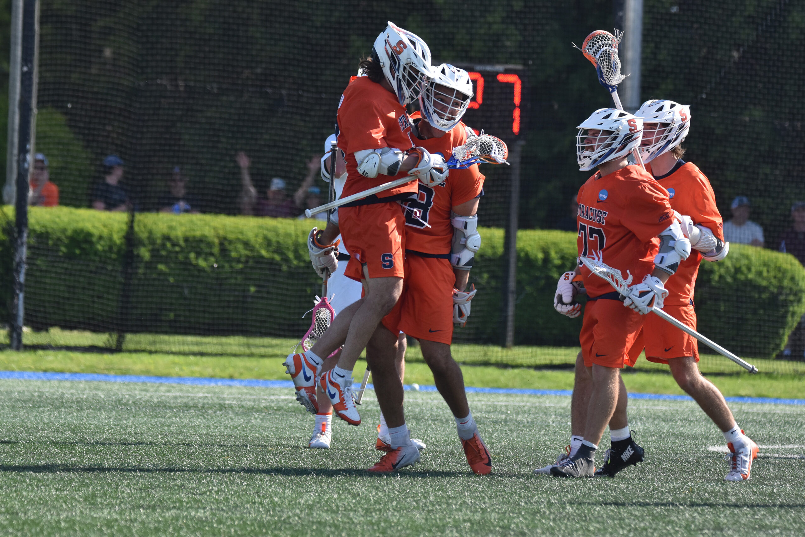 Syracuse Men's Lacrosse players grouped on the field