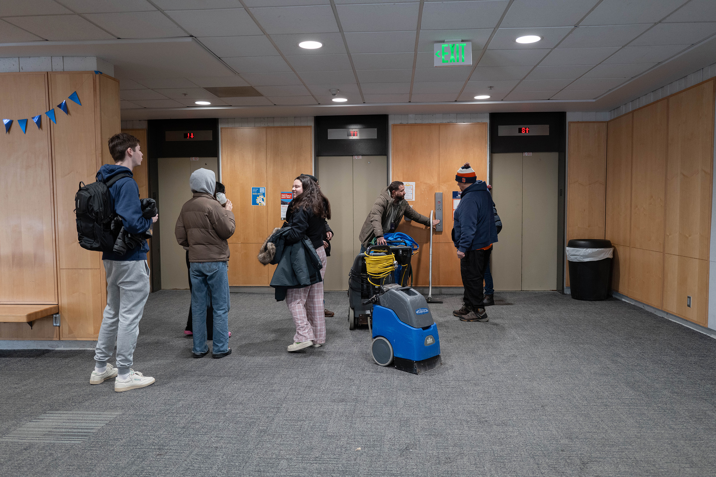 Students standing in the lobby of Brewster Hall.