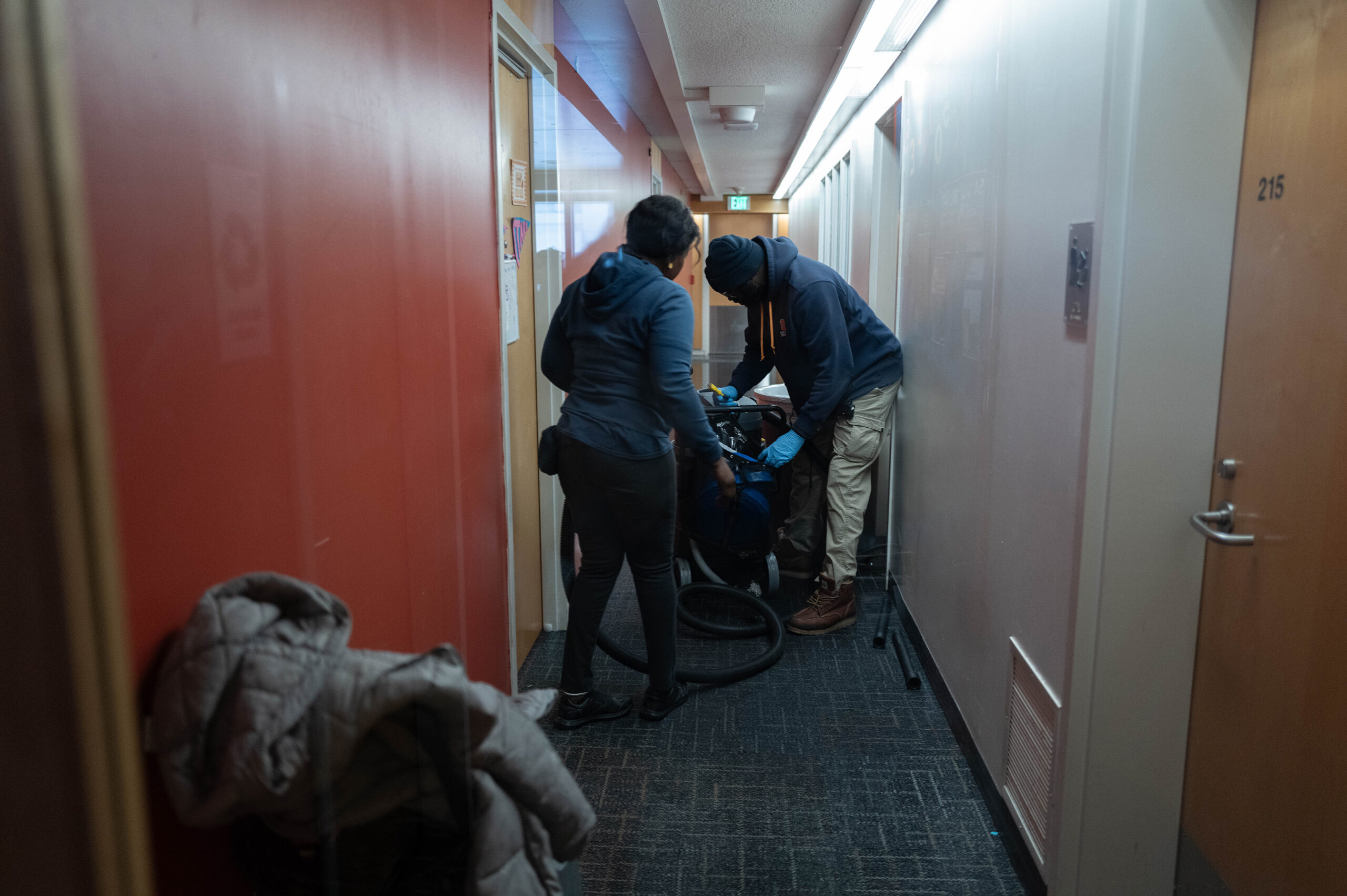 Building staff addressing the flooding in Brewster Hall.