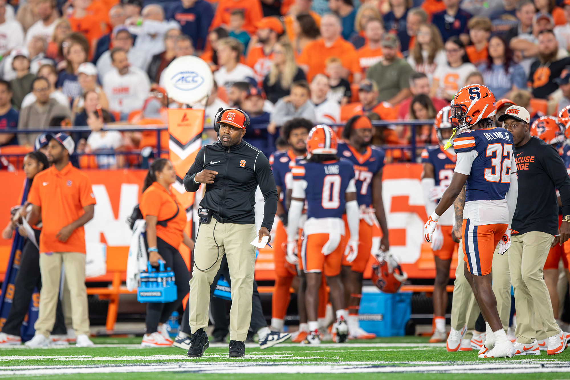 Photo of Syracuse football coaches and players on the sideline during a home game